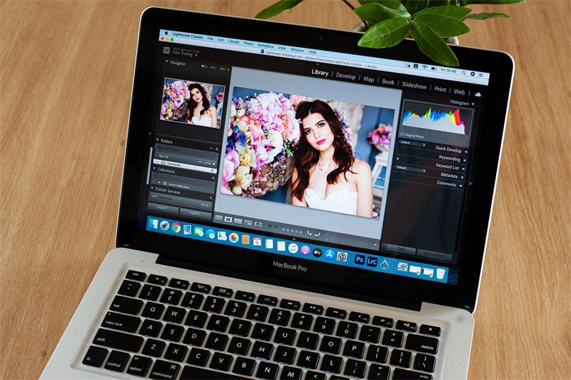 Laptop editing a portrait in photo software