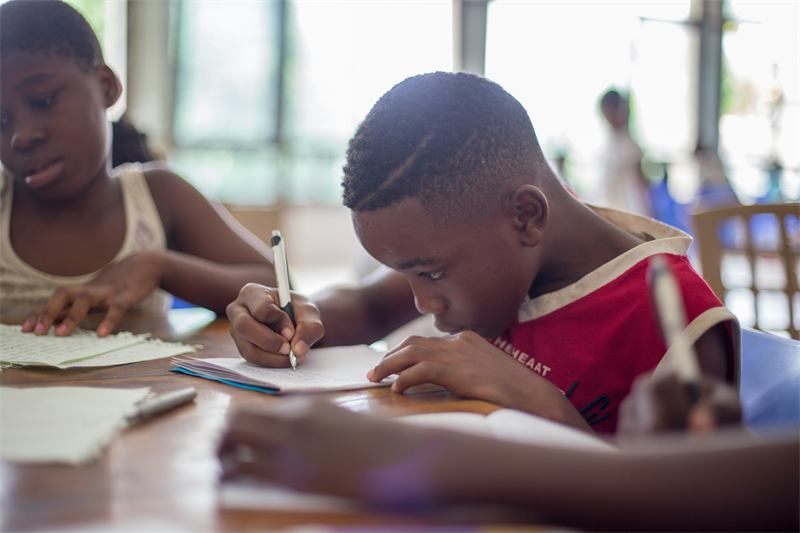 Students writing in their exercise books