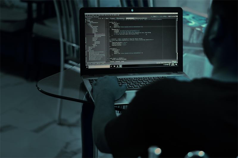Developer writing code on a laptop